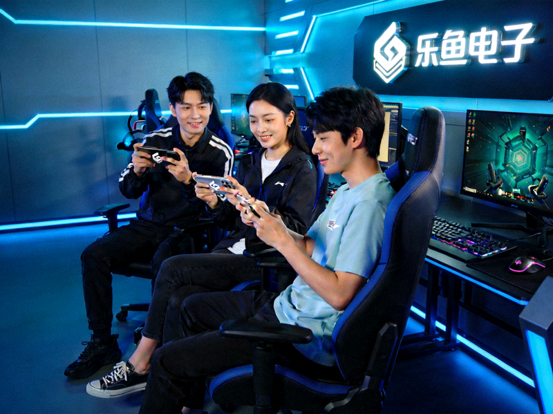 乐鱼电子品牌团队在科技感电竞工作室中协作讨论的场景